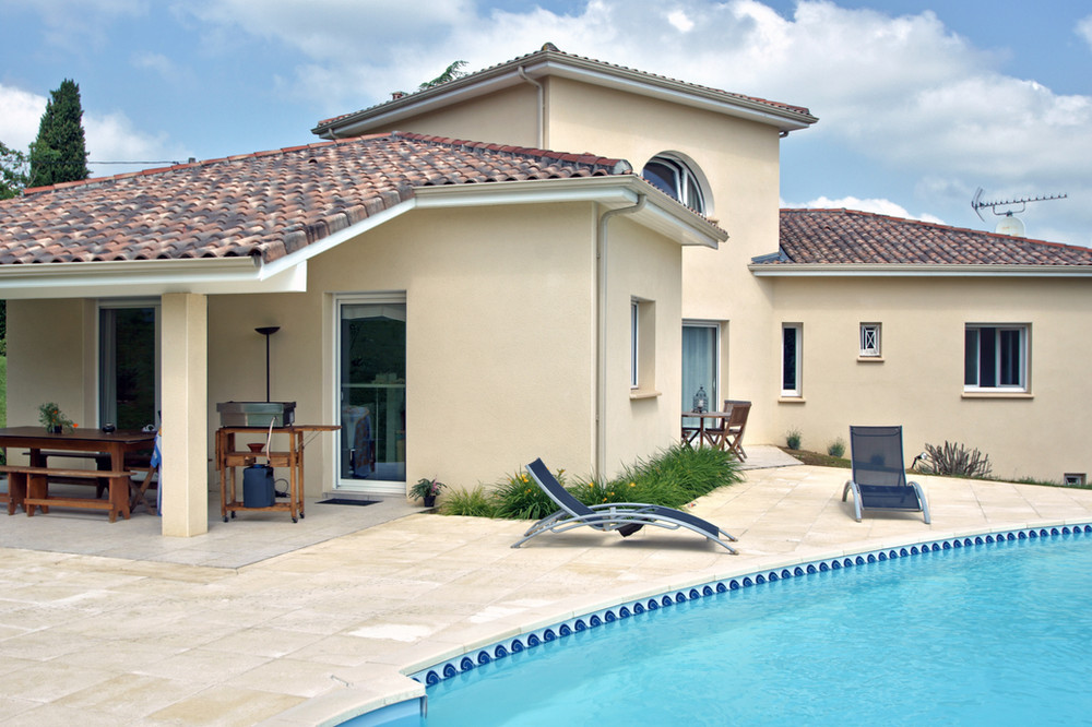 house with a pool and backyard dining area