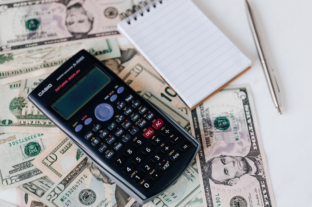 a calculator and usd cash