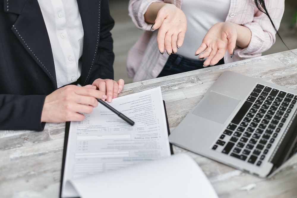 a contract on desk and women having conversation
